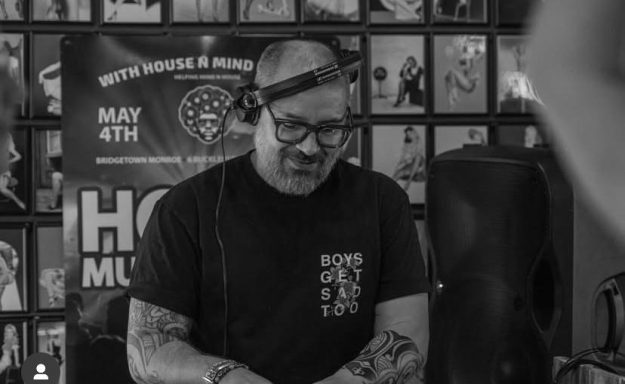DJ smiling and engaging with the audience during a funky house set.